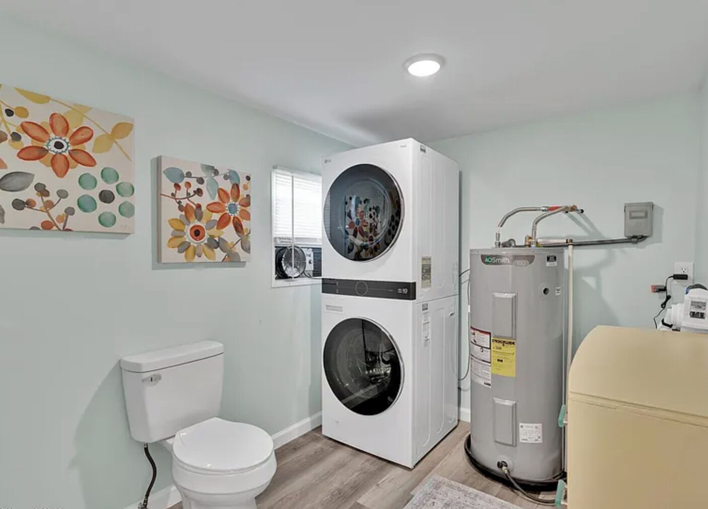 Convenient laundry area in full bath with modern LG washer/dryer 
