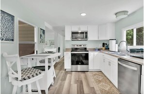 Fridge, microwave, oven, stovetop - Cozy Coastal Cottage - 5 Min to Holden Beach (Supply)