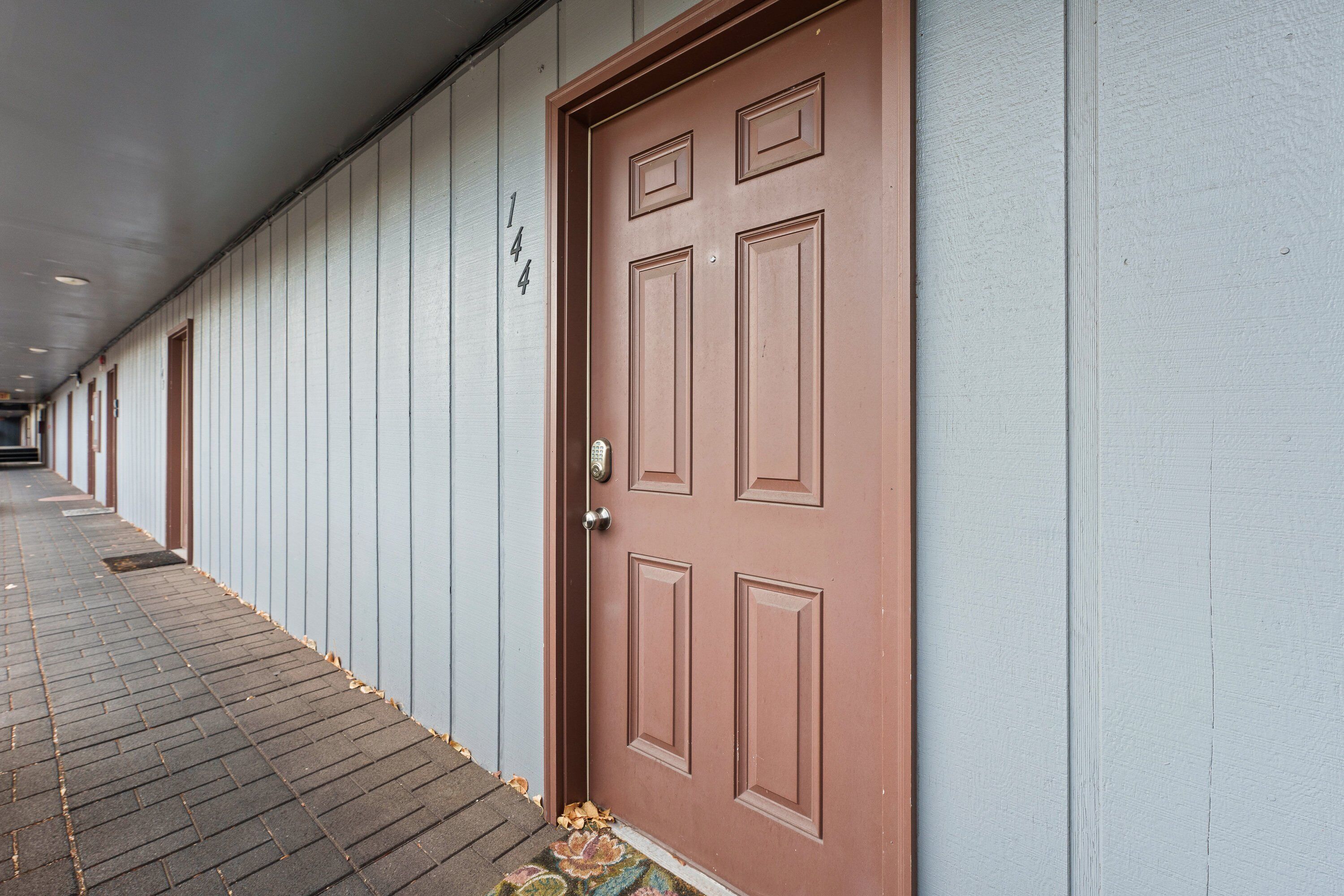 A row of doors with a number sign above, indicating a hotel or apartment building.
