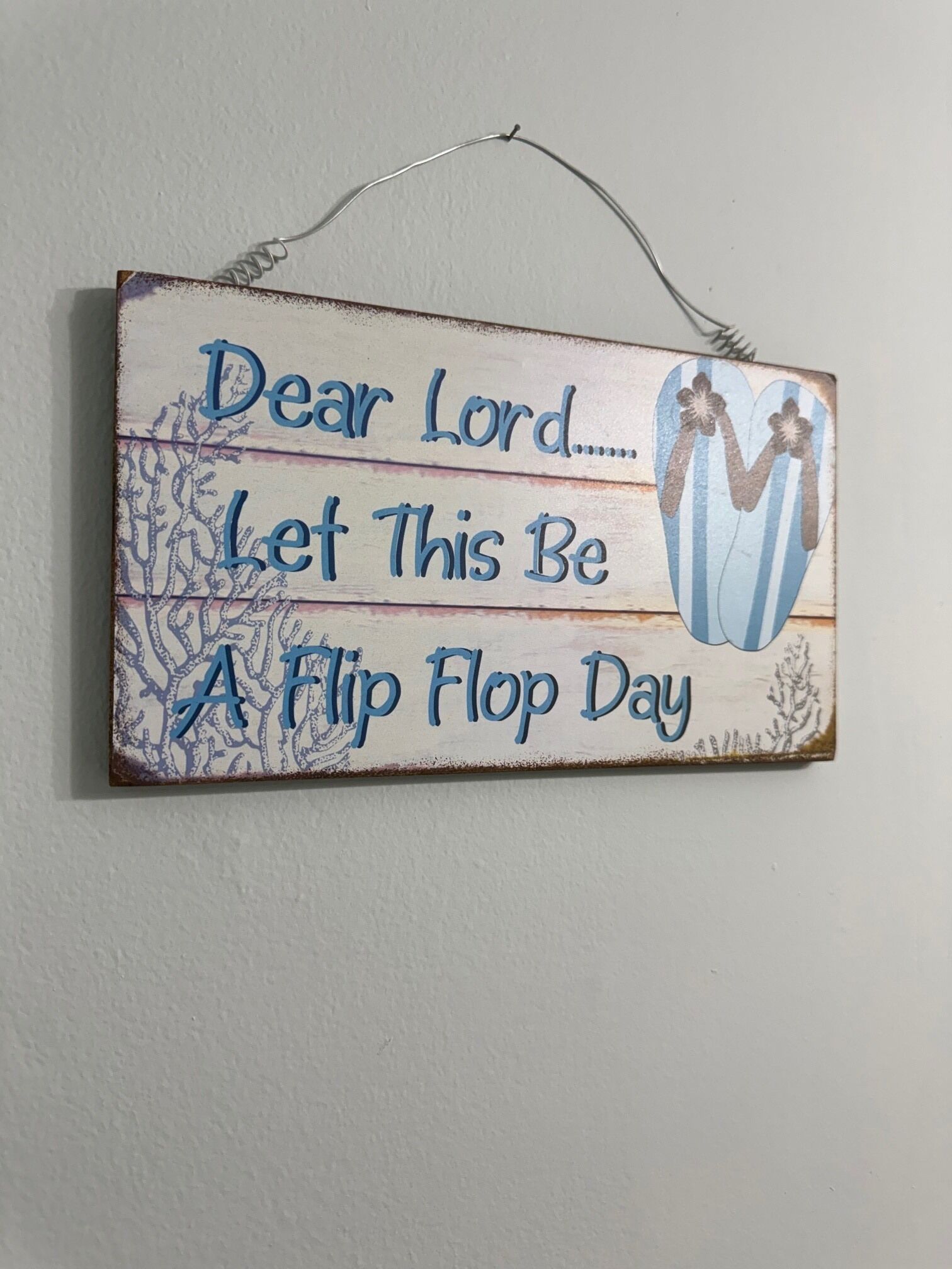 A decorative sign with the text "Dear Lord... Let This Be A Flip Flop Day" and a heart-shaped design.