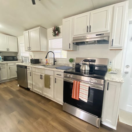 Fridge, microwave, oven, stovetop. Cozy & Inviting 3BR and 2 Bath • Full Kitchen + Laundry