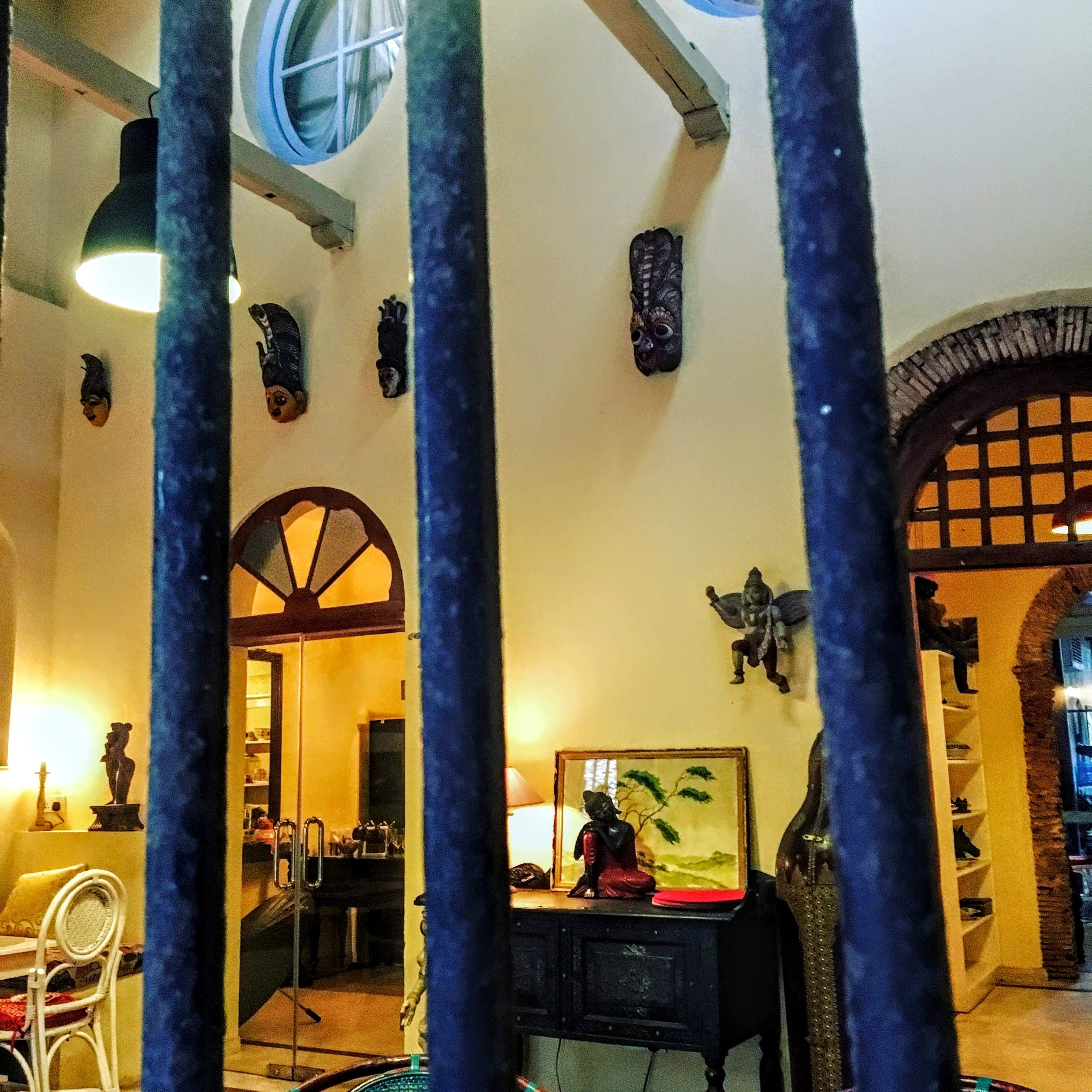 A room with a dining area, a staircase, and a view through a window.