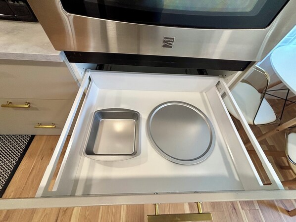 A kitchen drawer with a stainless steel microwave above it, a white countertop, and a patterned rug on the floor. - Newly Remodeled Modern 2bdrm•Workers Welcome• Soaker Tub (Big Spring)
