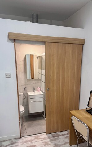 Ein modernes Badezimmer mit Toilette, Waschbecken und Spiegel.
