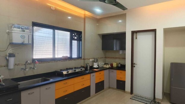 A compact kitchen with a sink, stove, and refrigerator.