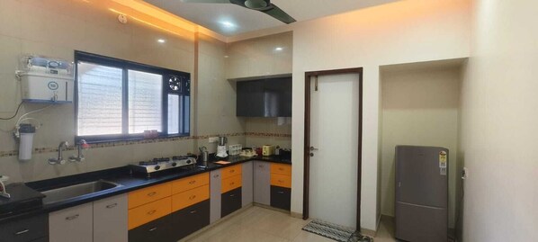 A compact kitchen with a sink, stove, and refrigerator.