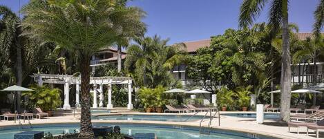 Slip into the refreshing lagoon pool beneath swaying palms.