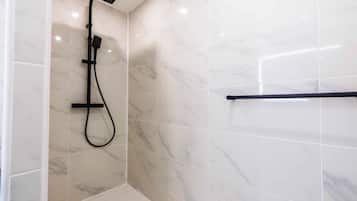 Shower, hair dryer, towels, shampoo