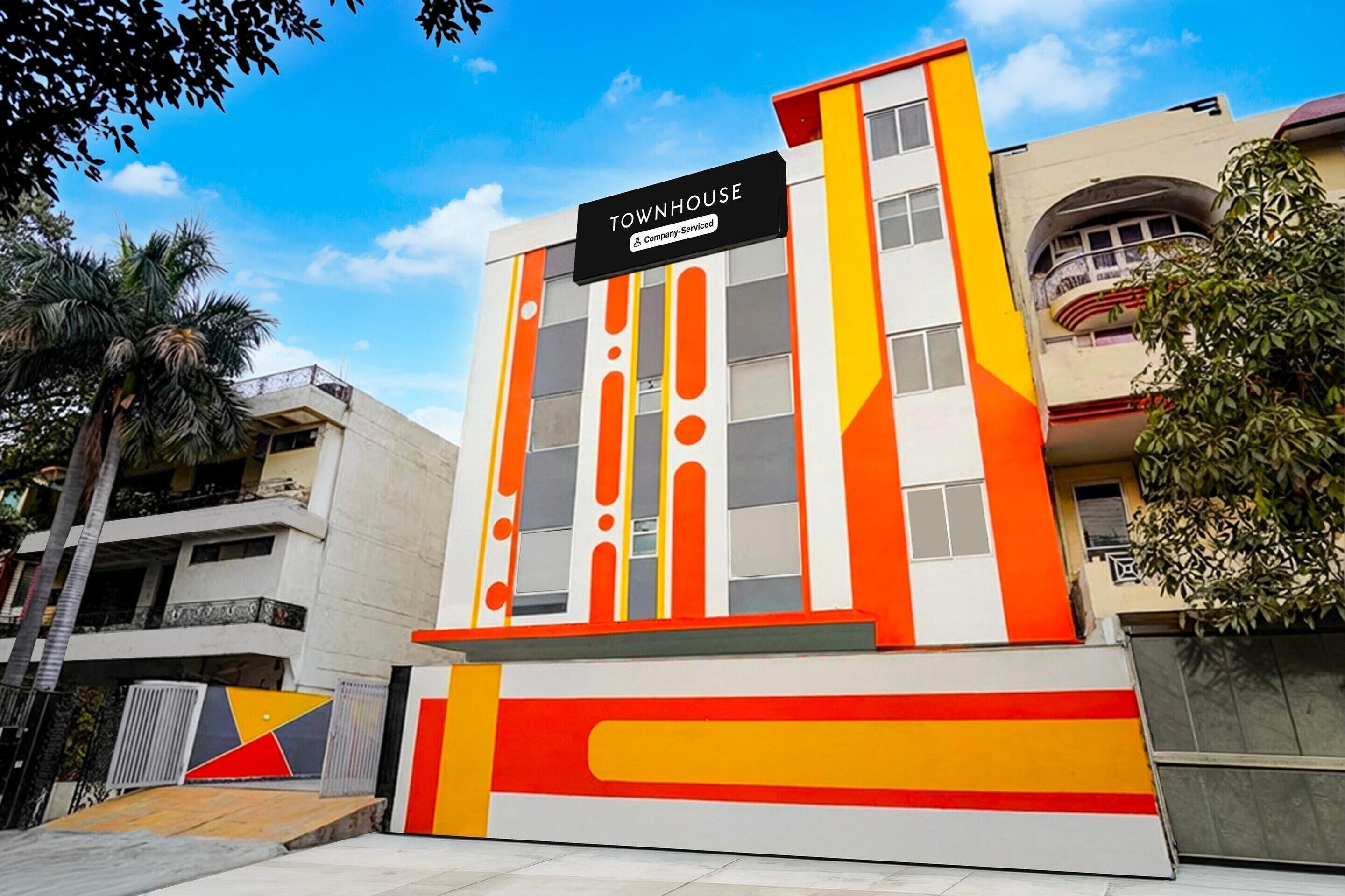 A building with a sign reading 'TOWNHOUSE' and a company service symbol.