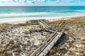 A beach with a wooden boardwalk leading to the shore. - Islander 603 2 Bedroom Condo (Destin)