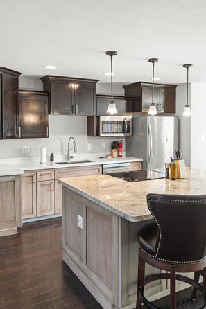Your gourmet kitchen awaits with granite counters, stainless appliances, and island seating for memorable meals together. - Relaxed Scottsdale Home | 4BR Near Old Town (Scottsdale)