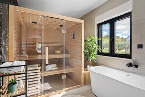 Private relaxation zone featuring a Finnish sauna and a luxury bathtub with garden views. - Stylish 4-Bedroom Villa Agrosa with 30 m2 Private Pool, Hydromassage, Finnish Sauna and Fun zone (Srinjine)