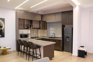 Apartment, Balcony | Private kitchen | Fridge, microwave, oven, stovetop - Heritage Residences-The Grey Lounge (Kampala)