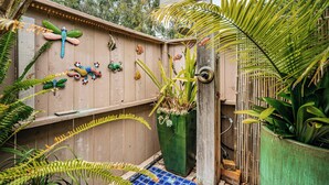 A wooden fence with decorative fish and a potted plant. - Fully Furnished 2BR Extended Stay Near UCSD & Scripps. Private Patio & Spa Bath (San Diego)