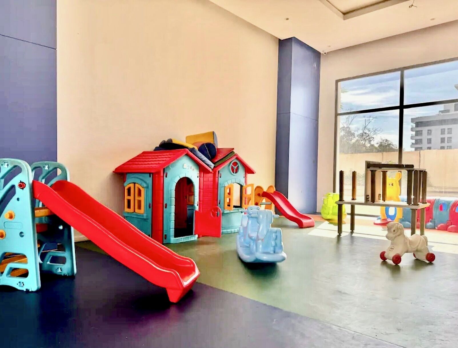 A children's play area with slides and a small house structure.