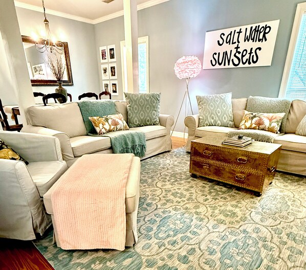 A living room with a sofa set, a coffee table, and a decorative lamp.
