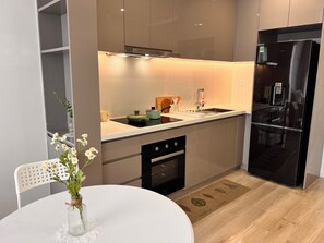 Deluxe Apartment, Balcony, River View | Private kitchen | Full-size fridge, oven, stovetop, cookware/dishes/utensils - Vinhomes Grand Park-Masterise Riverside (Ho Chi Minh City)