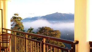 A staircase leading to a balcony with a view of a mountain range and clouds below. - Hotel Sky Gate Kandy  (Kandy)