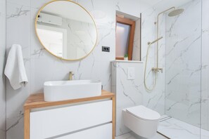 A bathroom with a white sink, a mirror, a toilet, and a shower. - Kresevo Family Villa With Heated Pool (Sestanovac)
