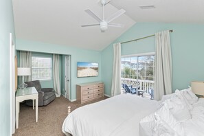 A bedroom with a bed, a desk, a chair, a dresser, and a window with curtains. - Private Heated Pool, Hot Tub, 1-min Walk to Beach, Pet Friendly, King Bed (Surfside Beach)