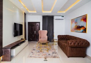 Luxury Apartment, Balcony, City View | Living area | Flat-screen TV, fireplace - Lavani Apartment and Suites (Benin City)