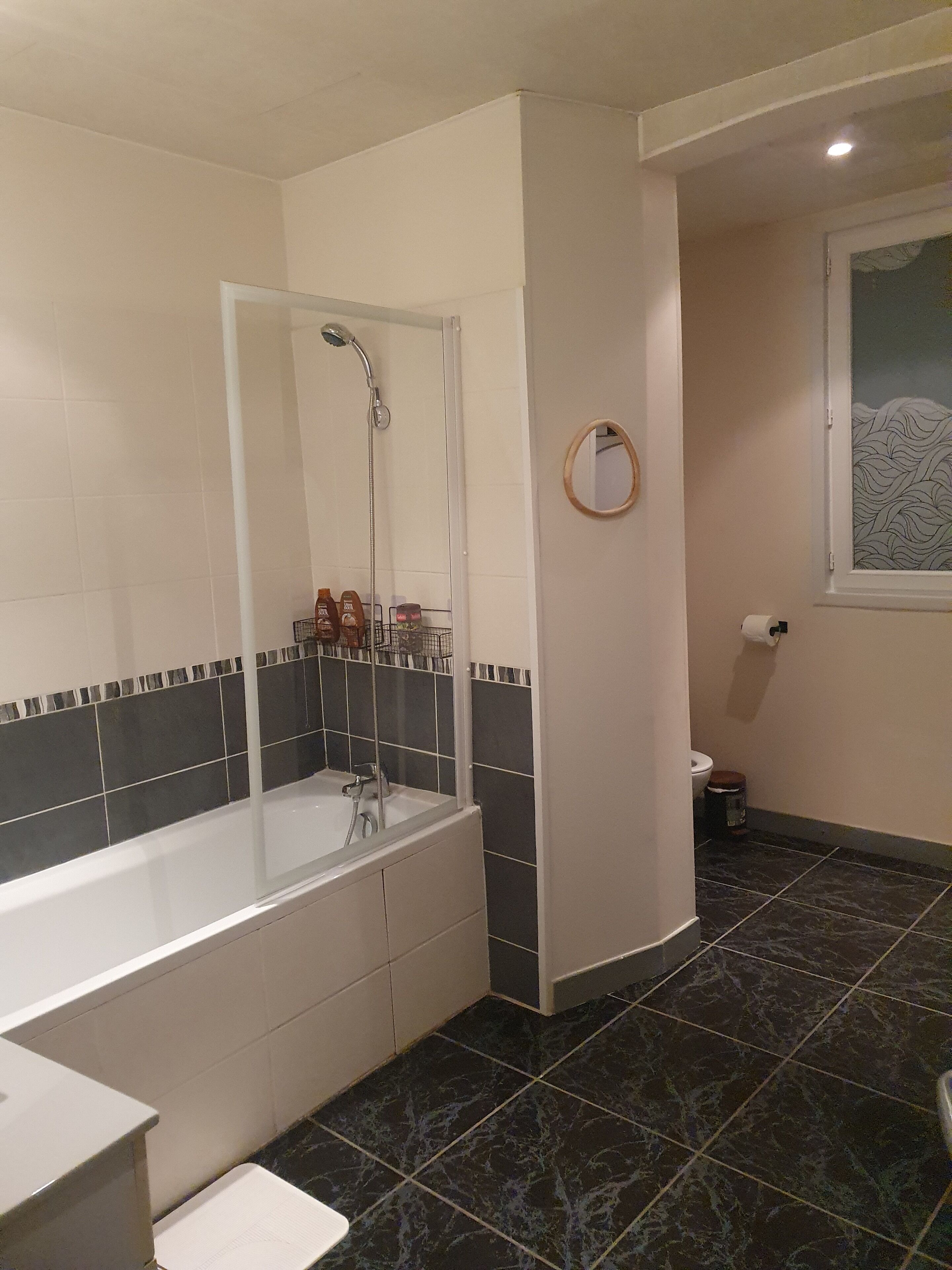 A bathroom with a bathtub, a shower, and a toilet.
