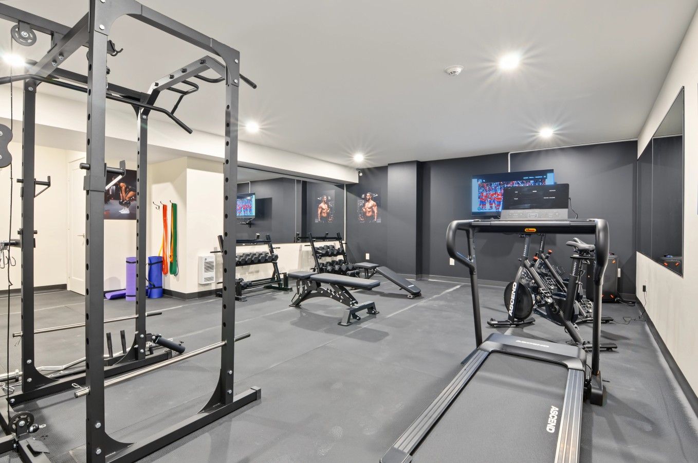 A modern gym with weightlifting equipment, treadmills, and exercise machines.