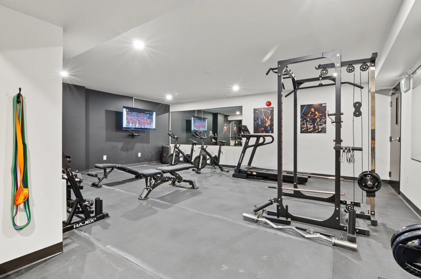 A gym with exercise equipment, treadmills, and weightlifting stations.