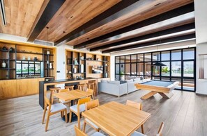 A modern interior with wooden floors, a pool table, and a dining area. - Valarte-Charming 2-bedroom apartment in Versalles (Puerto Vallarta)