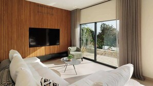 A modern living room with a flat-screen TV, a sofa, a coffee table, and a view of the outdoors. - Villa Alia, Modern Comfort Direct Beach Access (Corfu)