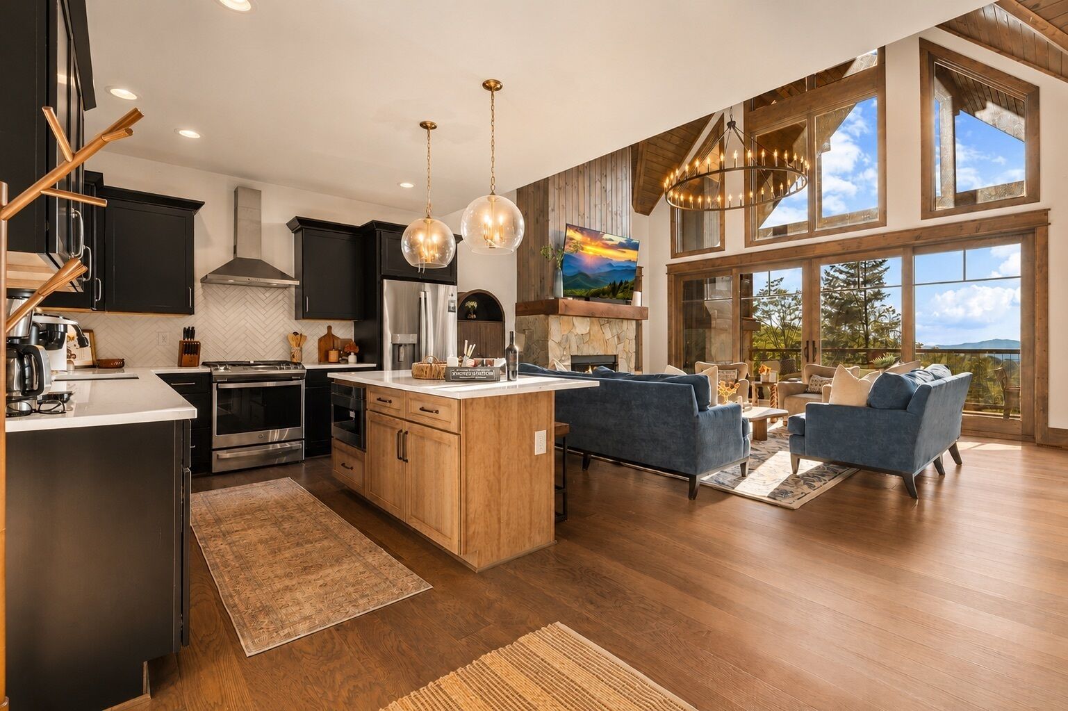 A modern kitchen with a central island, stainless steel appliances, and pendant lighting.