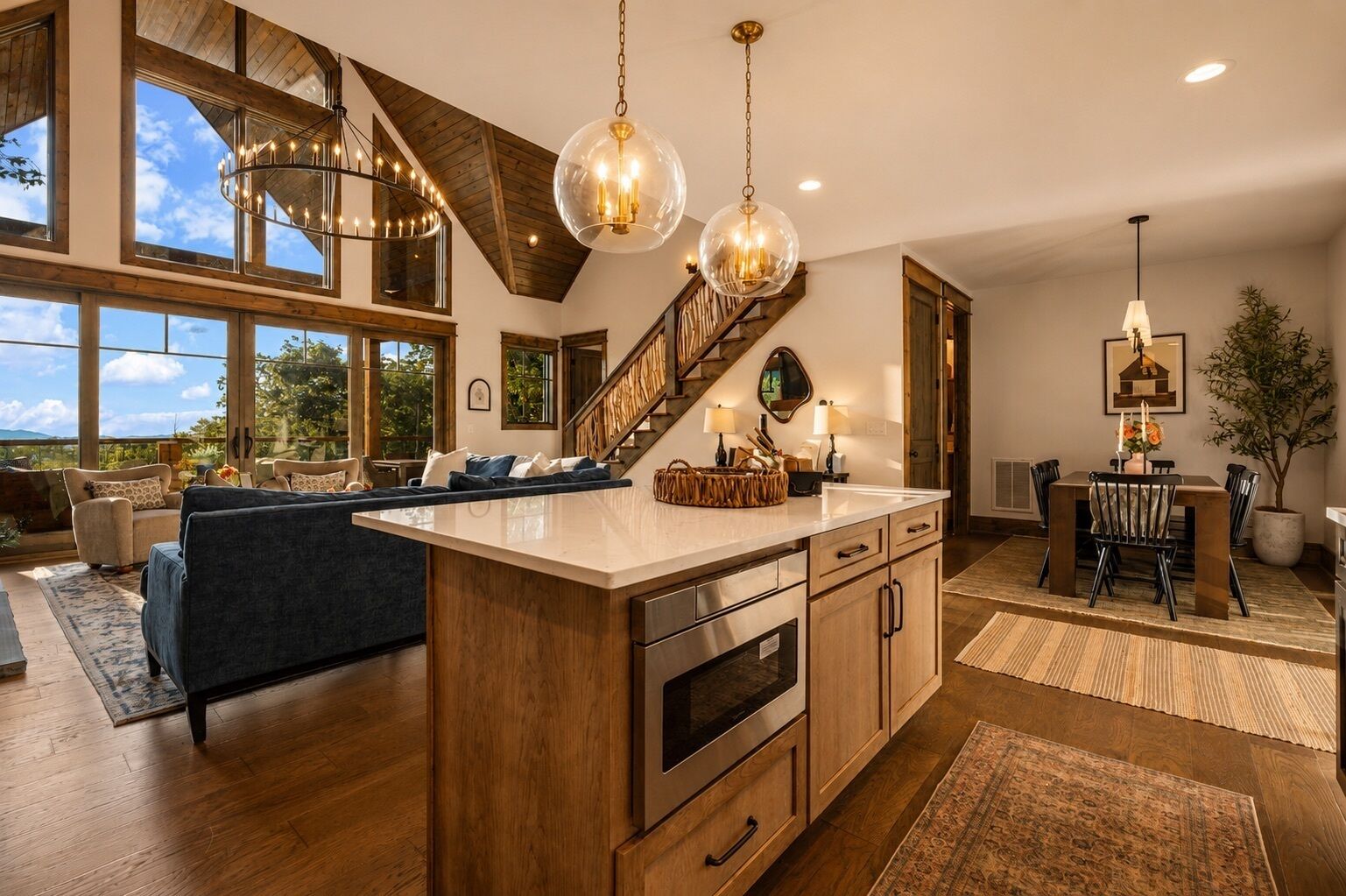 A spacious kitchen with a large island, wooden cabinetry, and a view of the outdoors.