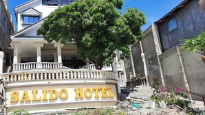 The entrance of Salido Hotel with a balcony, columns, and a tree in the foreground. - Breezy 18-Room Bed and Breakfast Perfect for Family Celebrations, Conferences (Manoc-Manoc, Boracay)
