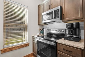 A kitchen with a built-in oven, microwave, and coffee maker. - Private Hot Tub at The Bobber Stop, Arcade, Community Pools Nearby & Free Attraction Tickets (Hollister)