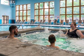 A swimming pool with a tiled edge, lounge chairs, and large windows. - Private Hot Tub at The Bobber Stop, Arcade, Community Pools Nearby & Free Attraction Tickets (Hollister)