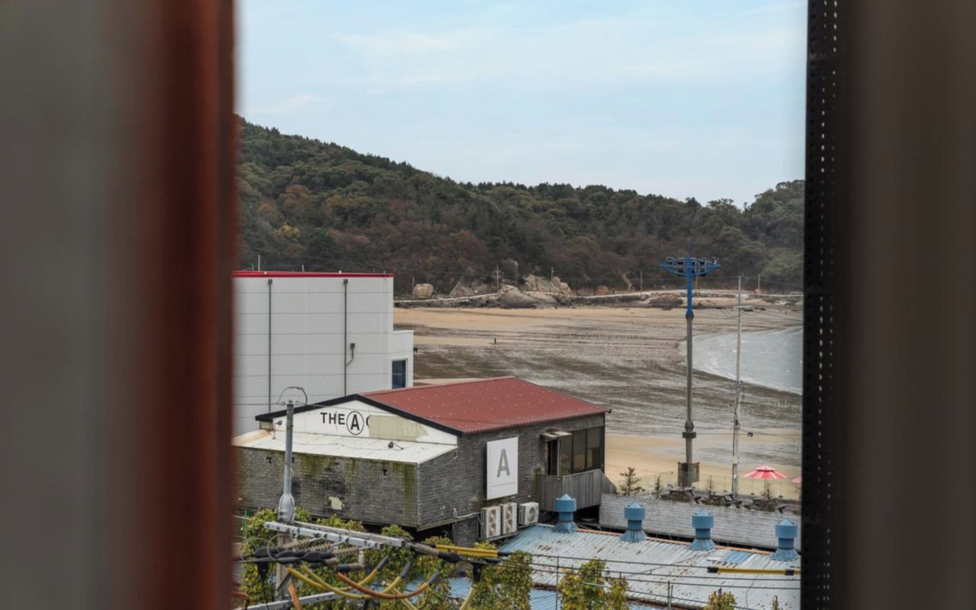 A coastal view with a building labeled 'THE A' and a beach in the background.