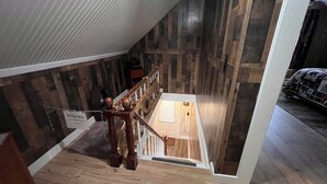 A wooden staircase with a 'No Access' sign, leading to a room with a bed and a wooden floor. - Charming 5-bedroom house in Jackman / Moose River perfect for families, groups. (Moose River)