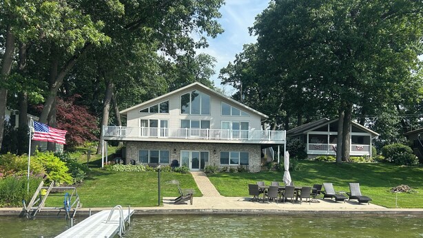 A two-story house with a balcony, a dock, and a swimming pool. - Magician Lakefront - 7 bedrooms, 4.5 baths, screened in porch and coffee bar. (Dowagiac)