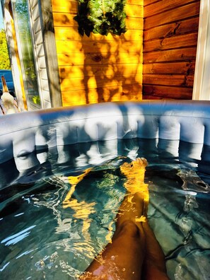 A hot tub with a wooden wall and a window.