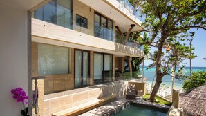 A modern building with a pool, glass balconies, and a view of the ocean. - Encantada Residences (Boracay Island)