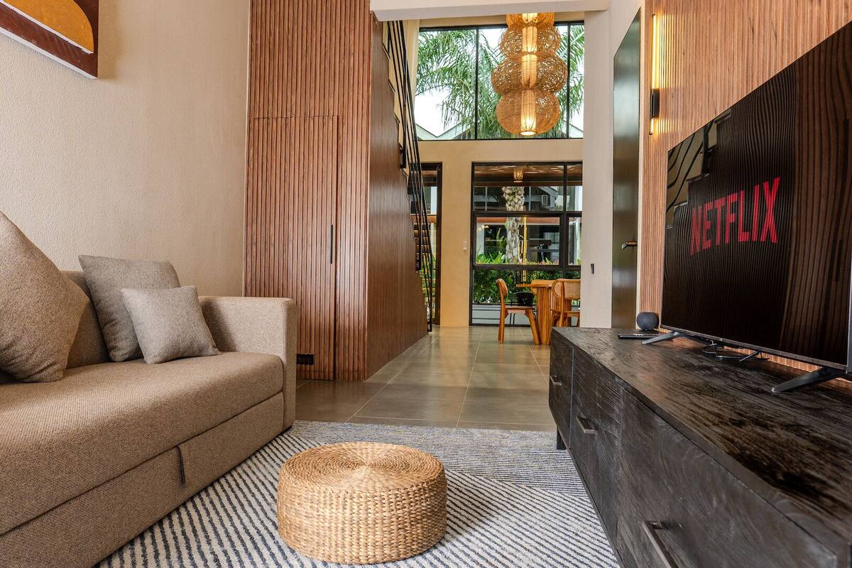 Deluxe Loft, Patio | Living area | Flat-screen TV, printers
