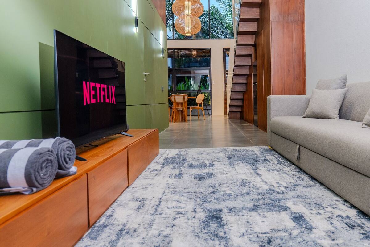 Deluxe Loft, Balcony | Living area | Flat-screen TV, printers