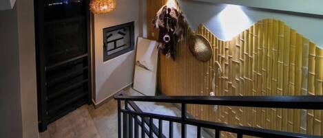 Ein modernes Interieur mit Treppe, Wanddekor und einer hängenden Maske.
