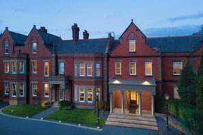 A large brick building with multiple windows and a prominent entrance. - Delta Hotels by Marriott Preston (Broughton)