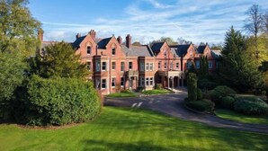A large, red brick building with multiple chimneys and a symmetrical facade. - Delta Hotels by Marriott Preston (Broughton)