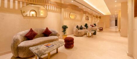 A modern interior with a sofa, ottoman, and a bench.