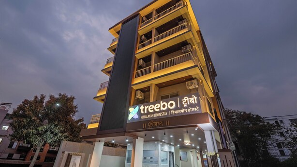 A multi-story hotel with balconies and air conditioning units. - Treebo Himalayan Homestay (Pune)