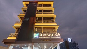 A multi-story hotel with balconies and a sign indicating it is a Himalayan homestay. - Treebo Himalayan Homestay (Pune)