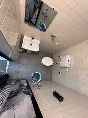A bathroom with a sink, toilet, and bidet. - Silver Sand Beach Homestay (Bhatkal)