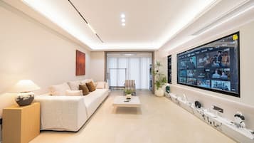 Deluxe Apartment | Living area | 100-inch Smart TV with digital channels